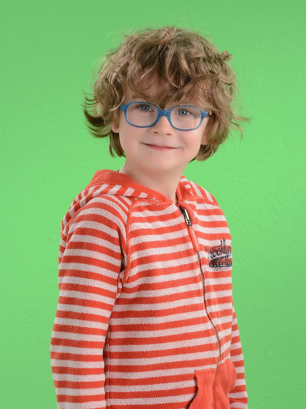 Professional school portrait retouching of a boy with glasses, featuring high-end background removal to pure white.			
